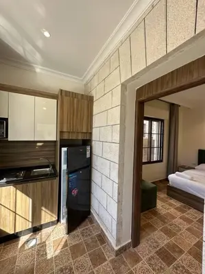 a room with a kitchen and a bedroom with a bed at 4/ Antica jabalal-lwebdeh in Amman