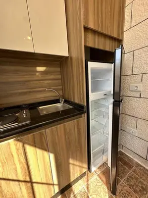 a kitchen with a sink and an open refrigerator at 4/ Antica jabalal-lwebdeh in Amman