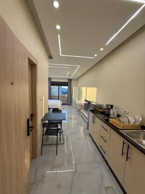 a large kitchen with a table and a dining room at Karak Plaza Residences in Kerak