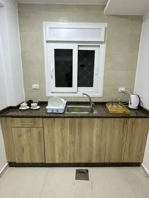a kitchen counter with a sink and a window at Karak Plaza Residences in Kerak