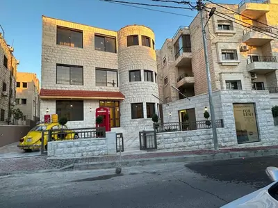 a yellow car parked in front of a building at 5/ Antica jabalal-lwebdeh in Amman