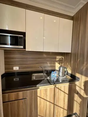 a kitchen with a sink and a microwave at 5/ Antica jabalal-lwebdeh in Amman