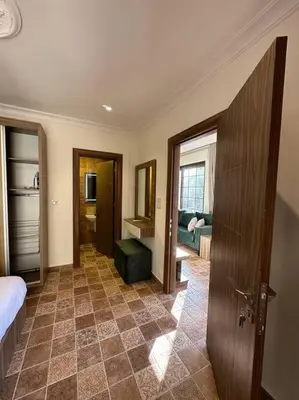 a room with a bedroom with a bed and a bathroom at 5/ Antica jabalal-lwebdeh in Amman