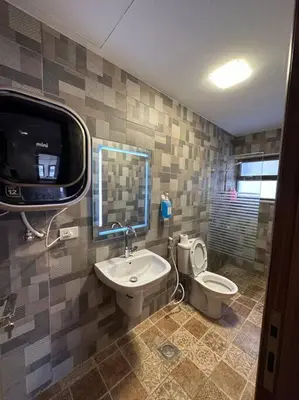 a bathroom with a sink and a toilet and a tv at 6/ Antica jabalal-lwebdeh in Amman