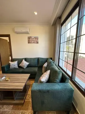 a living room with a couch and a table at 8/ Antica jabalal-lwebdeh in Amman
