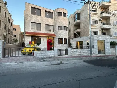 a yellow car parked in front of a building at 8/ Antica jabalal-lwebdeh in Amman