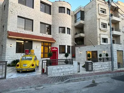 a yellow car parked in front of a building at X/ Antica jabalal-lwebdeh in Amman