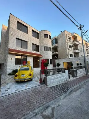 a yellow car parked in front of a building at XX/ Antica jabalal-lwebdeh in Amman