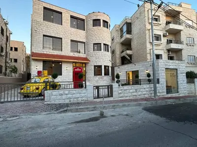 a yellow car parked in front of a building at XX/ Antica jabalal-lwebdeh in Amman