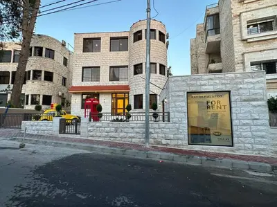 a building on the corner of a city street at XX/ Antica jabalal-lwebdeh in Amman
