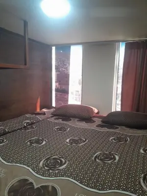 a large bed in a room with a view at Petra inbox Hostel in Wadi Musa