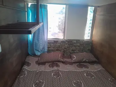 a bed in a room with a window at Petra inbox Hostel in Wadi Musa
