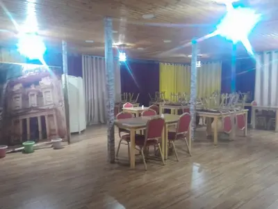 a dining room with tables and chairs and lights at Petra inbox Hostel in Wadi Musa