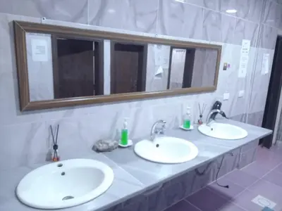 a bathroom with two sinks and a mirror at Petra inbox Hostel in Wadi Musa
