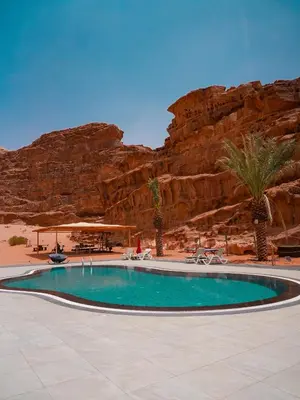 a swimming pool in the middle of a desert at Valley Resort in Wadi Rum