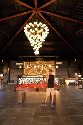 a man standing in front of a pool table at Valley Resort in Wadi Rum
