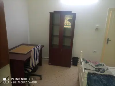 a bedroom with a dresser and a bed and a cabinet at Decapolis with garden in Irbid