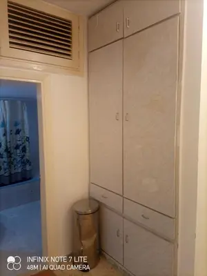 a bedroom with a large closet with white cabinets at Decapolis with garden in Irbid