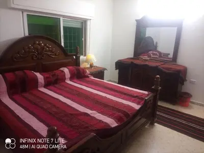 a bedroom with a large bed and a mirror at Decapolis with garden in Irbid