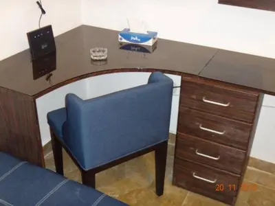 a desk with a blue chair in a room at Royal Luxury Amman Central Apartments in Amman