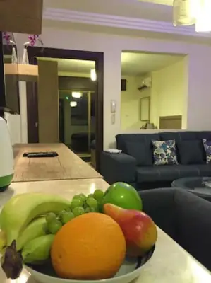 a bowl of fruit on a counter in a living room at Royal Luxury Amman Central Apartments in Amman