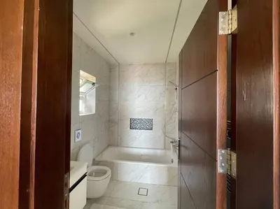 a bathroom with a bath tub and a toilet at Horizon Villa in Amman