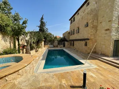 a swimming pool in front of a building at Horizon Villa in Amman