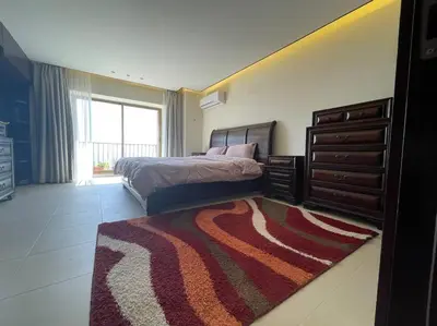 a bedroom with a bed and a dresser and a rug at Horizon Villa in Amman
