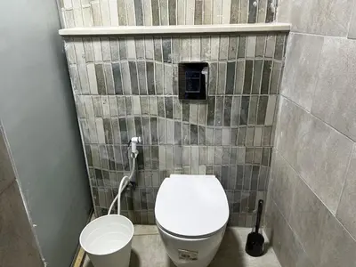 a small bathroom with a toilet and a sink at Downtown Inn Madaba in Madaba
