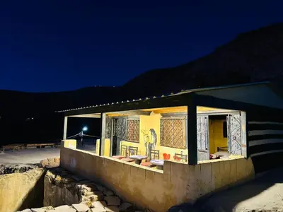 a building with a painting on the side of it at night at Dana Tower Hotel in Dana