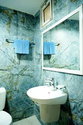 a bathroom with a sink and a mirror at Conord Hotel in Amman