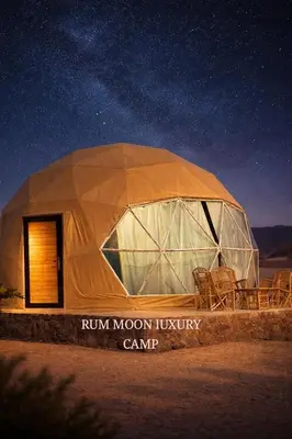 a dome tent with chairs in the desert at night at RUM MOON lUXURY CAMP in Wadi Rum
