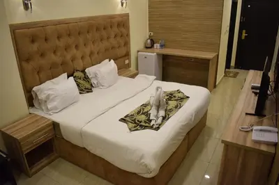 a hotel room with a bed with towels on it at Nour Hotel in Amman
