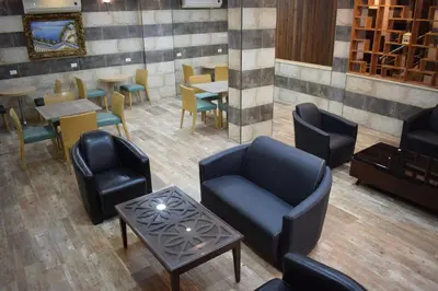 an overhead view of a restaurant with chairs and tables at Nour Hotel in Amman