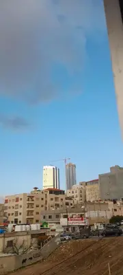 a view of a city with buildings in the background at Gentle Breeze Studio 1 in Amman