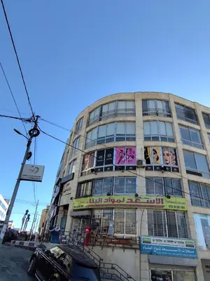a tall building with advertisements on the side of it at Gentle Breeze Studio 1 in Amman