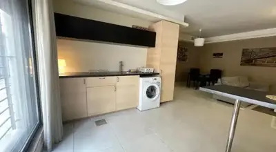 a kitchen with a washing machine in a room at Luxurious cozy apartment in Amman