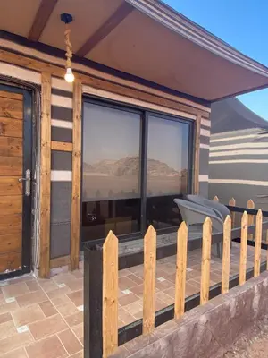 a deck with a view of the desert from a house at Dessert flowers wadi rum in Disah