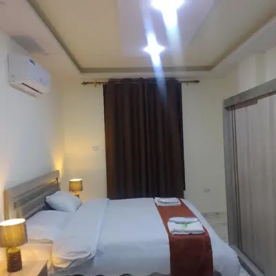 a bedroom with a large bed and a light on the ceiling at Dream Hotel jerash in Jerash