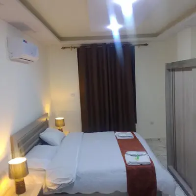 a bedroom with a large bed with a black curtain at Dream Hotel jerash in Jerash