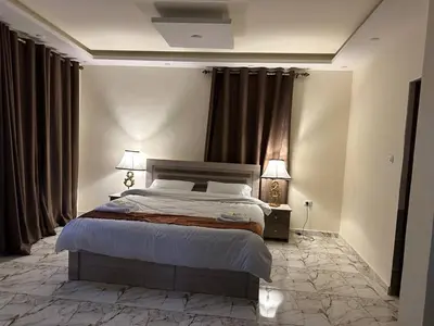a bedroom with a bed and two lamps and curtains at Dream Hotel jerash in Jerash