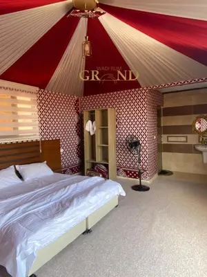 a bedroom with a bed in a circus tent at WADI RuM GRAND in Wadi Rum
