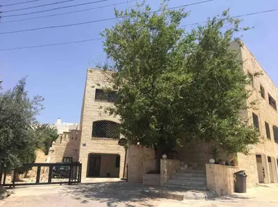 a stone building with a tree in front of it at ‘C’ DAZZLING MODERN 2 BDRM APT IN KHALDA Free WIFI in Amman