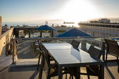 a table and chairs on the roof of a building at My Hotel by Trend in Aqaba