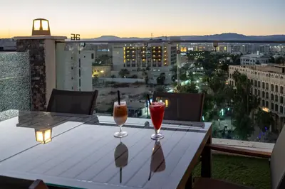 two drinks on a table on a balcony with a view at My Hotel by Trend in Aqaba