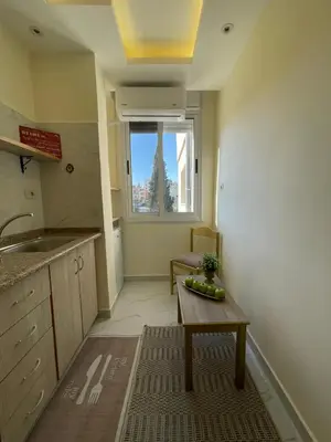 a small kitchen with a table and a window at Classy Guesthouse in Madaba