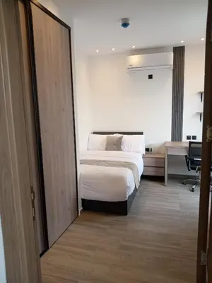a hotel room with a bed and a desk at Alshakreen suites in Amman
