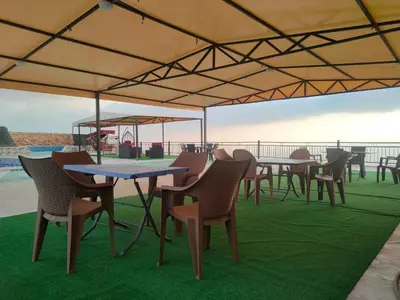 a group of tables and chairs under a tent at Magical Rosemary Chalet in Al Mashāriqah