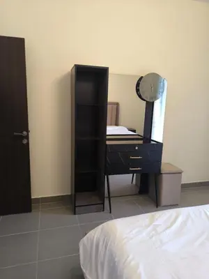 a bedroom with a dresser and a mirror and a bed at EP2 Samarah Resort in Sowayma