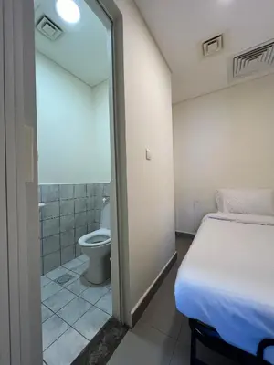 a bedroom with a bed and a bathroom with a toilet at EP2 Samarah Resort in Sowayma